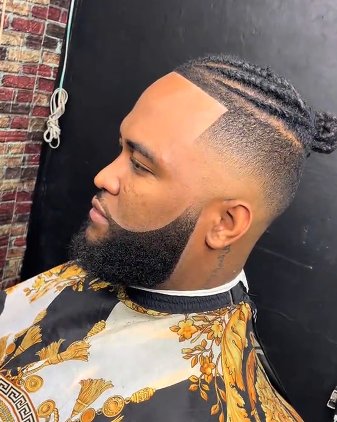 Braids, fade and full beard shape-up by Military Cutz
